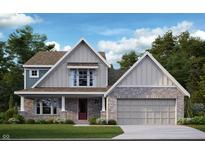 Charming two-story home featuring brick and siding accents, a cozy porch, and an attached two-car garage at 527 Firefly Ct, Greenfield, IN 46140