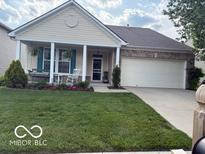 Charming home featuring a covered porch, manicured lawn, and a two-car garage at 5304 Appleseed Way, Indianapolis, IN 46217