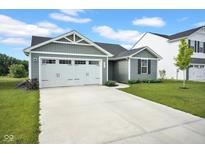 Charming single-Gathering home boasts a well-maintained lawn, a two-car garage, and classic architectural details at 7171 E Rising Sun S Cir, Camby, IN 46113