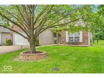 Charming single-story home with well-manicured lawn, mature shade tree, and inviting brick accents at 8315 Exton Rd, Indianapolis, IN 46239