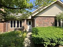 Charming brick home with a well-maintained front yard and inviting entrance at 10712 Downing St, Carmel, IN 46033