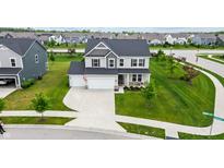 Beautiful two-story home with a well-manicured lawn and a spacious two car garage at 11809 Redpoll Trl, Noblesville, IN 46060