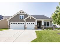 Charming home featuring a three-car garage, stone accents, and manicured lawn, with an inviting facade and neutral color palette at 1283 Clairet, Westfield, IN 46074