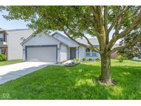 Charming single-story home with a well-maintained lawn and attached two-car garage at 14255 Holly Berry Cir, Fishers, IN 46038