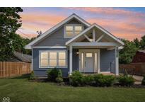 Charming home showcasing architectural details, fresh landscaping, and inviting front porch at 2928 Mounds Rd, Anderson, IN 46016
