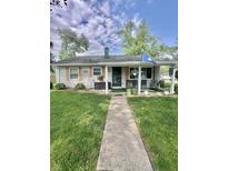 Charming single-story home with a covered front porch and well-manicured lawn with mature trees at 3101 Danbury Rd, Indianapolis, IN 46222