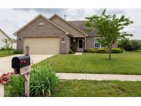 Charming single-Gathering home with a brick facade, lush lawn, and well-maintained landscaping at 4353 W Parkway Ct, New Palestine, IN 46163