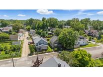 An aerial shot of a peaceful neighborhood, featuring tree-lined streets and well-maintained homes under a sunny sky at 4715 E New York St, Indianapolis, IN 46201