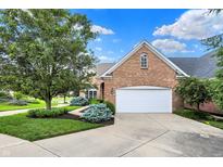 Charming brick home featuring a two-car garage and beautifully landscaped front yard at 4810 Crystal River Ct, Indianapolis, IN 46240