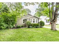 Charming single-story home with well-maintained lawn and mature trees at 5119 Norwaldo Ave, Indianapolis, IN 46205
