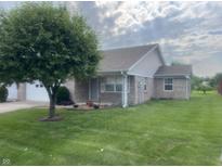 Charming single-story home with a well-maintained lawn, mature tree, and neutral brick exterior at 5632 Spring Mist Cir, Indianapolis, IN 46237