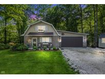 Charming home featuring brick accents, an attached garage, and a well-manicured lawn surrounded by lush trees at 5824 Wesley Rdg, Martinsville, IN 46151