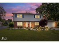 Charming two-story home with brick and vinyl exterior, landscaped yard, and inviting front entrance at 6133 Buttonwood Dr, Noblesville, IN 46062