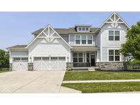 Charming two-story home with a three-car garage, stone accents, and a well-maintained lawn at 6160 Hardwick Dr, Whitestown, IN 46075
