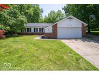 Inviting one-story home with manicured lawn, mature trees, and attached two-car garage at 640 Shady Creek Ct, Greenwood, IN 46142