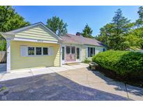 Charming yellow home with a well-manicured lawn and inviting front entrance at 6514 Jackson St, Indianapolis, IN 46241