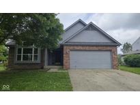 Charming home featuring a brick and siding facade, a well-manicured lawn, and an attached two-car garage at 7168 Camwell Dr, Indianapolis, IN 46268