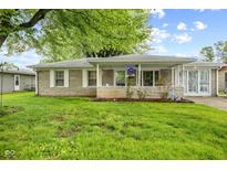 Charming single-story home with stone facade, manicured lawn, and covered porch at 861 Westbrook Dr, Mooresville, IN 46158