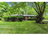 Charming single-story brick home with a well-maintained lawn and mature trees at 9101 Ditch Rd, Indianapolis, IN 46260