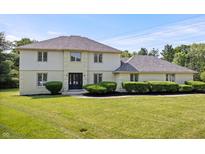 Charming two-story home boasts a well-manicured lawn, mature landscaping, and a welcoming front entrance at 9205 Selkirk Ct, Indianapolis, IN 46260