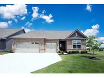 Charming brick home featuring a two-car garage, well-manicured lawn, and beautiful landscaping at 9671 Holborn Ave, McCordsville, IN 46055