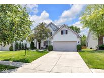 Charming two-story home with a well-manicured lawn, driveway, and attached two-car garage at 10215 Lauren Pass, Fishers, IN 46037