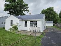 Charming single-story home with a white exterior and well-maintained front yard at 1102 S Dequincy St, Indianapolis, IN 46203