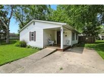 Charming one-story home with a covered porch and landscaped front yard, offering a welcoming curb appeal at 1120 W 5Th St, Greenfield, IN 46140