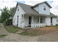 A charming two-story home with a covered front porch, offering a cozy and inviting curb appeal at 121 School St, Greenfield, IN 46140