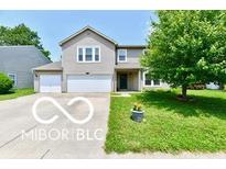 Charming two-story home with a well-maintained lawn, a two-car garage, and attractive landscaping at 1252 Jasmine Dr, Greenfield, IN 46140