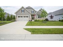 Charming home features a manicured lawn, two-car garage, and inviting walkway at 16209 Natures Way, Westfield, IN 46074