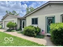 Charming single-story home with a well-maintained lawn, lush shrubs, and an inviting entrance at 1802 Laurel Dr, Columbus, IN 47203