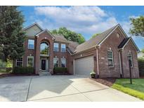 Beautiful two-story brick home with a manicured lawn, a two-car garage, and a concrete driveway at 18112 Kinder Oak Dr, Noblesville, IN 46062
