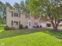 Charming two-story home with traditional siding, manicured lawn and attached two car garage at 2126 Tartan Rd, Anderson, IN 46012