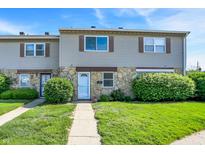 Charming townhome featuring stone accents, vinyl siding, and a well-manicured lawn at 2642 Country Estates Dr, Indianapolis, IN 46227