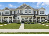 Charming townhome featuring stone accents, well-maintained lawn, and covered front porch at 3613 Lehigh Ave, Westfield, IN 46074
