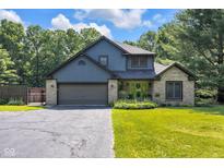 Charming two-story home boasts a lush green lawn, mature trees, and a welcoming green front door at 3715 Pitkin Rd, Martinsville, IN 46151