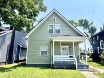 Charming exterior of home featuring neutral siding, white trim, covered porch, and well-maintained landscaping at 3835 N Kenwood Ave, Indianapolis, IN 46208