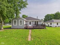 Charming home featuring a spacious backyard with a wooden deck, perfect for outdoor entertaining at 624 10Th St, Chesterfield, IN 46017