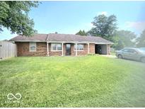 Brick home with a well-manicured lawn, attached garage, and a classic suburban appeal at 731 Sunset Blvd, Greenwood, IN 46142