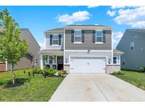 Charming two-story home boasts a manicured front yard and a two-car garage, providing both curb appeal and functionality at 741 Scarsdale Ln, Danville, IN 46122
