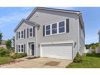 Charming two-story home with gray siding, black shutters, and a two-car garage, enhancing curb appeal at 7854 Wolfgang Pl, Indianapolis, IN 46239