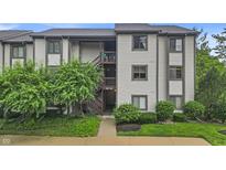 Inviting condo exterior with well-maintained landscaping and a charming, multi-level entryway at 8176 Shorewalk Dr # C, Indianapolis, IN 46236