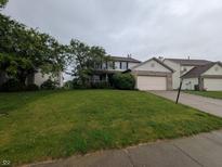 Charming two-story home featuring a lush green lawn and attached two car garage at 10150 Beresford Ct, Fishers, IN 46038