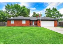 Charming brick home with a well-manicured lawn and attached two-car garage at 11630 Deanna Dr, Indianapolis, IN 46229