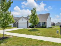 Charming home featuring manicured lawn, attached garage, and beautiful landscaping on a sunny day at 12105 Fall Ct, Indianapolis, IN 46229