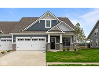 Charming home with stone accents, a white garage door, and a well-manicured lawn at 12500 Morning Ridge Way, Noblesville, IN 46060