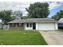 Charming single-story home with brick facade, attached garage, and well-maintained front lawn at 3259 Pawnee Dr, Indianapolis, IN 46235