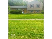 A charming two-story home featuring a well-maintained lawn and welcoming curb appeal at 3570 Decamp Dr, Indianapolis, IN 46226