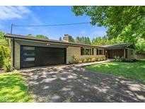 Charming single-story home with attached garage, brick facade, and well-maintained landscaping at 4350 Sylvan Rd, Indianapolis, IN 46228